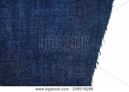 Piece of dark blue jeans fabric isolated on white background. Rough uneven edges.
