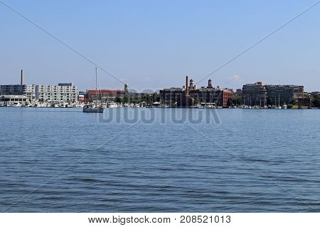 A sailboat and other boats around the harbor near Baltimore, Maryland.