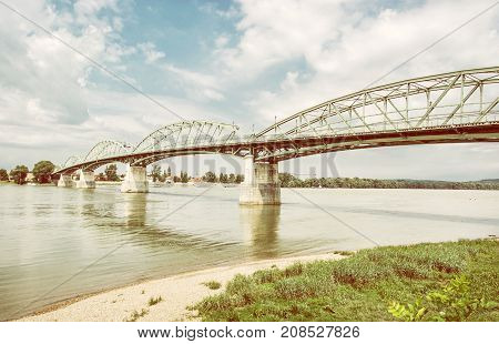 Maria Valeria bridge joins Esztergom in Hungary and Sturovo in Slovak republic across the Danube river. Transportation theme. Architectural scene. Yellow photo filter.