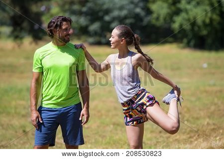 Smiling Couple Stretching Outdoors