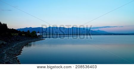 View on level water in dam Liptovska Mara with the background of the Havranok church.