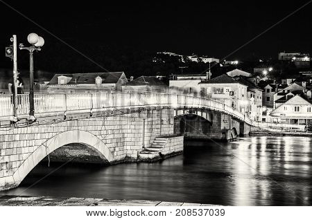 Bridge from Trogir to Ciovo island Croatia. Night scene. Travel destination. Black and white photo.