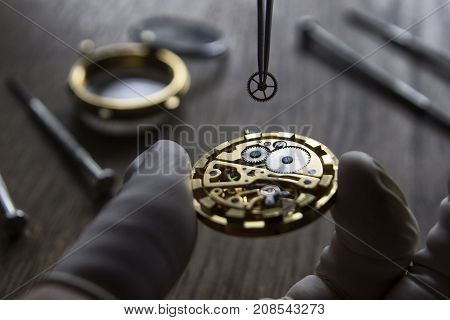 Watchmaker is repairing the mechanical watches in his workshop