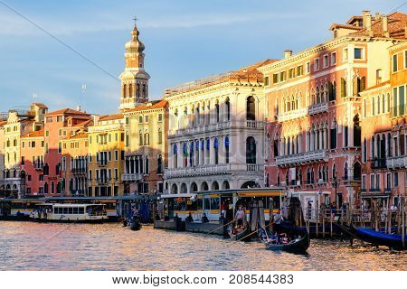 VENICE,ITALY - JULY 25,2017 : Gondolas and vaporetti on the Grand Canal in Venice surrounded by old palaces