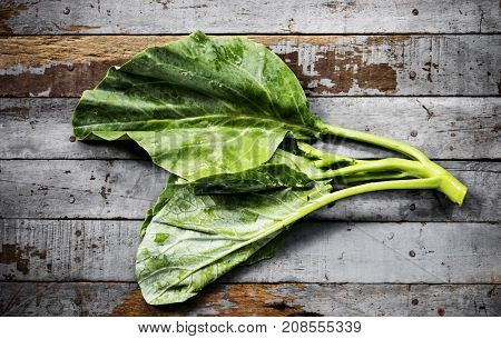 Aerial view of fresh collard chinese kale on wooden background