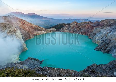 Colorful Ijen Volcano Crater Lake And Raung Volcano At The Background.
