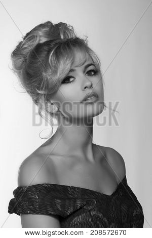 portrait of a beautiful blonde woman in retro dress 50-s style . copy space. vintage look. babetta haircut. monochrome black and white photo