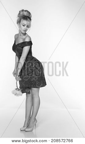portrait of a beautiful blonde woman in retro dress 50-s style . copy space. vintage look. babetta haircut. monochrome black and white photo
