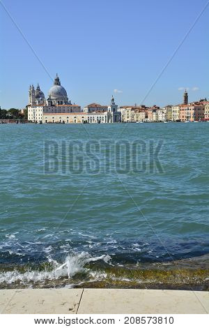 A view of Dorsodoro in Venice taken from the San Giorgio Maggiore with the Giudecca Canal on the left and the Grand Canal on the right. The church of Santa Maria Della Salute (Saint Mary of Health) can be seen towering above the other buildings and Punta
