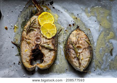 Grilled yellowtail amberjack just cooked fillets with lemon slices.