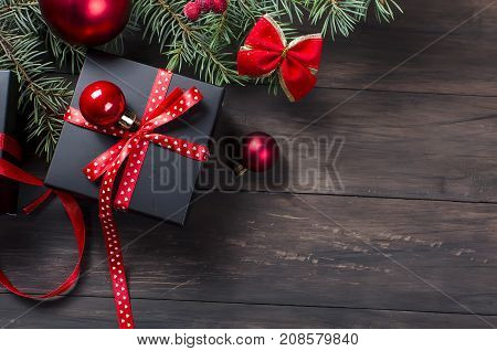 Black Christmas  Gift  Box With Red Ribbon And Fir Branches
