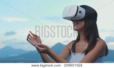 Woman watching on VR device on roof top 
