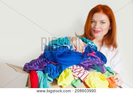 A Woman Is Busy With The Clutter In Her Wardrobe.