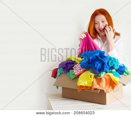 A Woman Is Busy With The Clutter In Her Wardrobe.