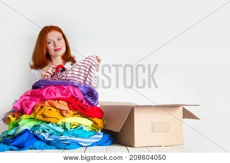 A Woman Is Busy With The Clutter In Her Wardrobe.
