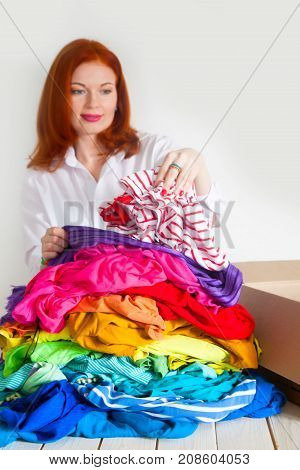 A Woman Is Busy With The Clutter In Her Wardrobe.