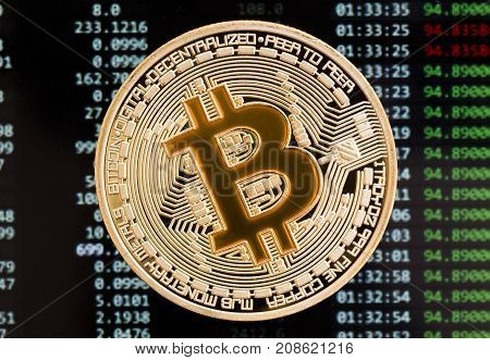 Golden Bitcoin cryptocurrency yellow coin on a circuit board background. High resolution photo.