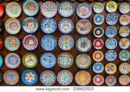 NESEBAR BULGARIA - AUGUST 21 2017: Background of plates with traditional national patterns. Showcase of a private shop selling souvenirs and gifts.