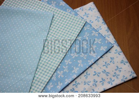Multicolored cuts of fabric against the background of boards
