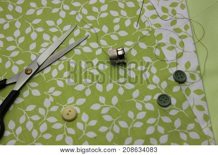 Multicolored cuts of fabric with coils of thread on the background of boards