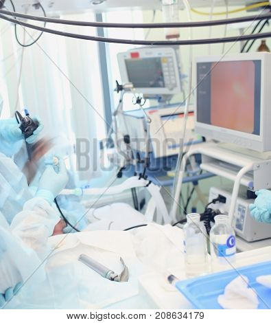 Medical procedure during video control in the ICU.