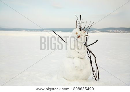 deformed ugly winter snowman in open space
