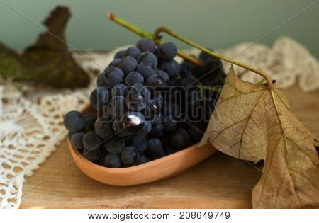 Grapes In A Clay Plate On A Wooden Background. Rustic Style, Selective Focus.