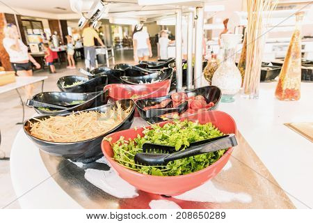 Salad black bowls with fresh vegetables buffet breakfast