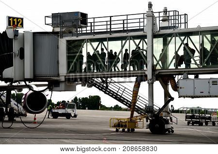 Passengers Boarding On Airplane