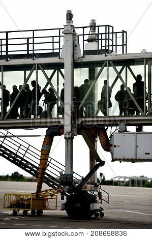 Passengers Boarding On Airplane
