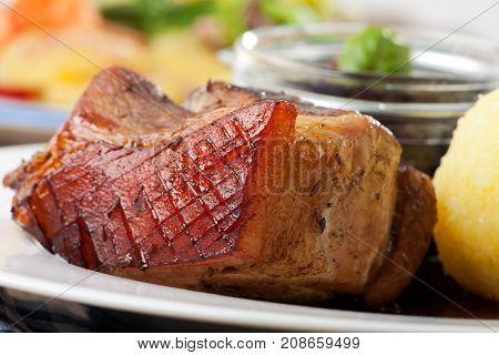 closeup of bavarian roast pork dish with dumplings