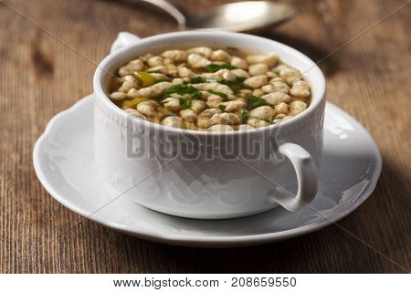 portion of bavarian bratnockerl soup on wood