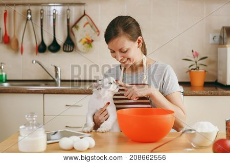 A Young Beautiful Happy Woman With A White Persian Cat Prepares Dough For Christmas Cakes With Table