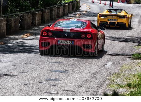 GOLA DEL FURLO, ITALY - MAY 19: FERRARI YELLOW AND RED  on an old racing car in rally Mille Miglia 2017 the famous italian historical race (1927-1957) on May 19 2017