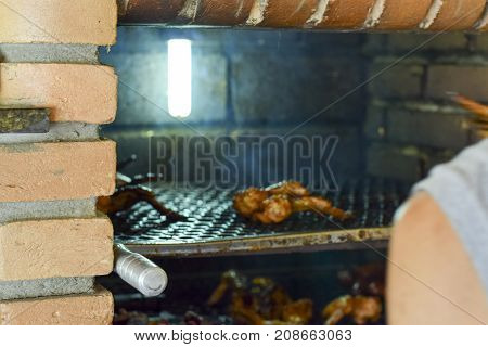 Brazilian Man Tending To Churrasco
