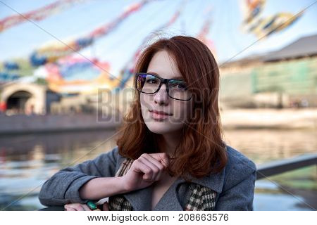 A thoughtful girl in glasses thinks in some university to enter for her a very important career and a place in life she wants to develop in the sphere of communication and communication with people.