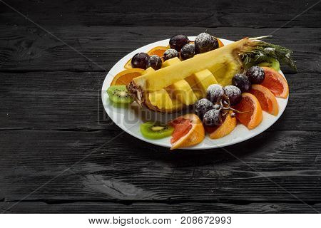 Fruit Plate On A Dark Wooden Background