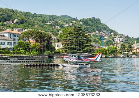 Como Italy - May 27 2016: The seaplane Cessna 172N Skyhawk 100 II docking on at water aerodrome of Como lake in Como City Italy.