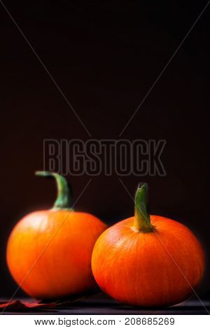 Happy Thanksgiving Day background - orange pumpkins over wooden table. Autumn nature concept.
