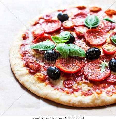 Pizza with cherry tomatoes and ham. Hot Original Italian Pepperoni pizza