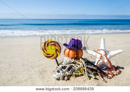 Beach Happy Halloween background with pumpkin candy and starfish