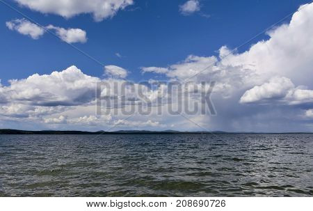 Bright Clouds Reflected In The Water