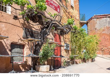 ROUSSILLON FRANCE - APRIL 27 2016: Street of medieval village of Roussillon. It ochre village is included in list of 