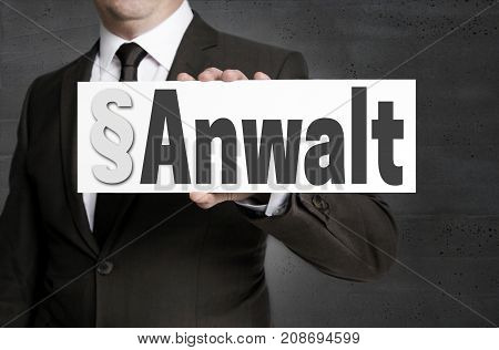 Anwalt (in german Attorney) shield is held by businessman.