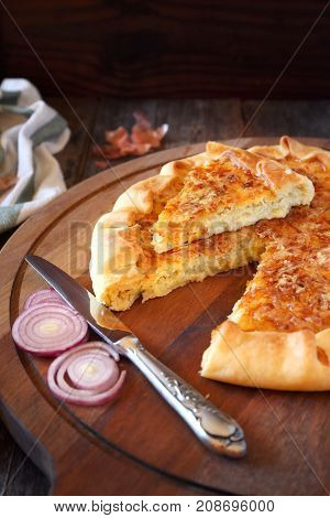 Onion cheese pie on wooden table rustic style