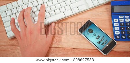 Digitally composite image of We Want You text with icons against man typing on keyboard at desk in office