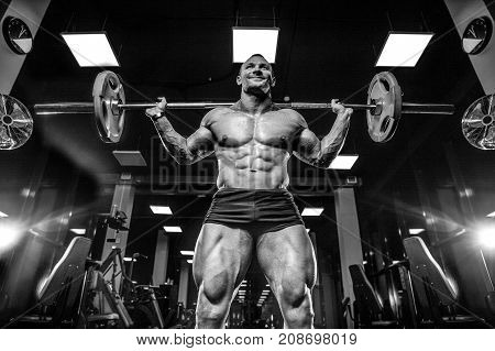 Handsome Model Young Man Training Legs In Gym