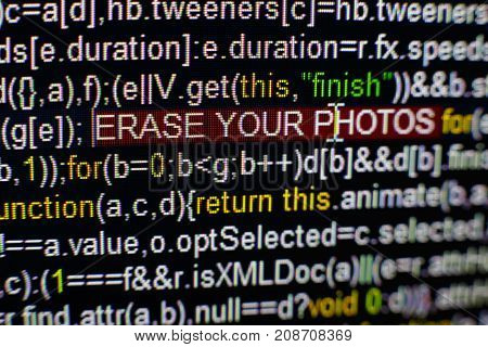 Macro photo of computer screen with program source code and highlighted SPYWARE inscription in the middle. Computer script on the screen with virus in it. Cyber security concept.