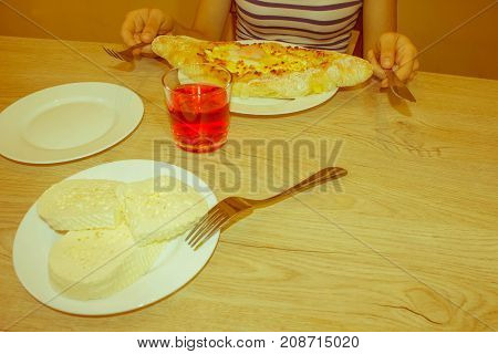 Adjarian khachapuri with eggs on the table. Delicious homemade khachapuri in Adjarian - Retro color