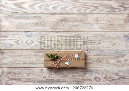 Gift box with red ribbon over white wooden background. Copy space top view.
